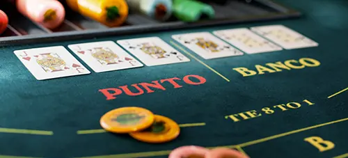Live Punto Banco casino table with dealer and card layout