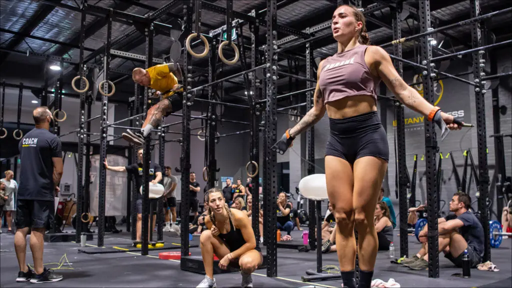 CrossFit athletes training with jump ropes and gymnastic rings