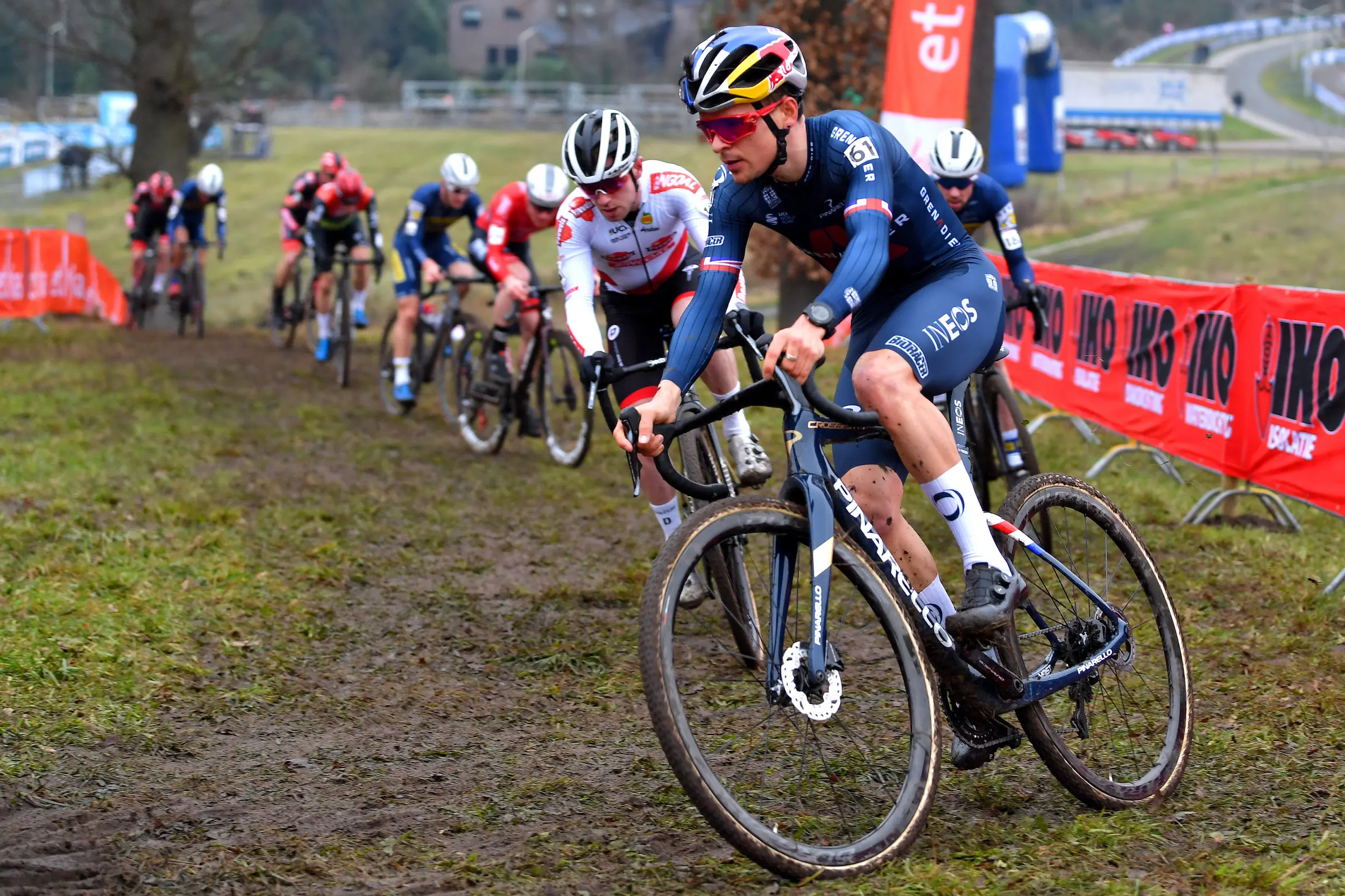 Cyclo-cross riders racing on a muddy course