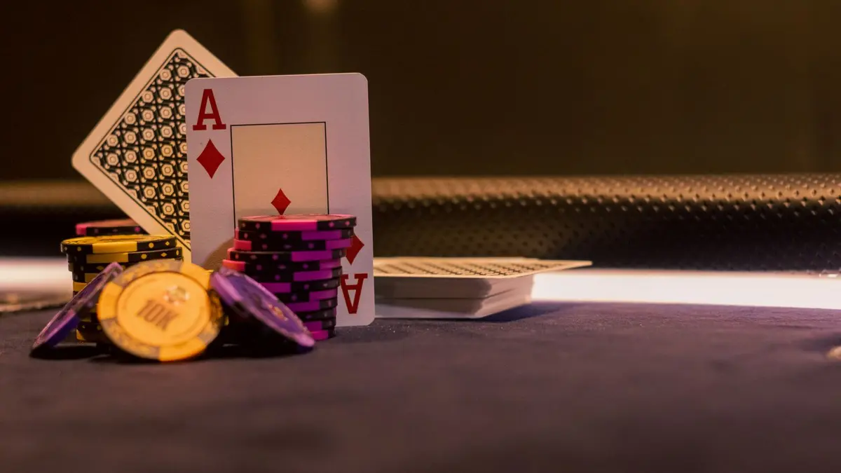 Cards and casino chips representing game contribution rules