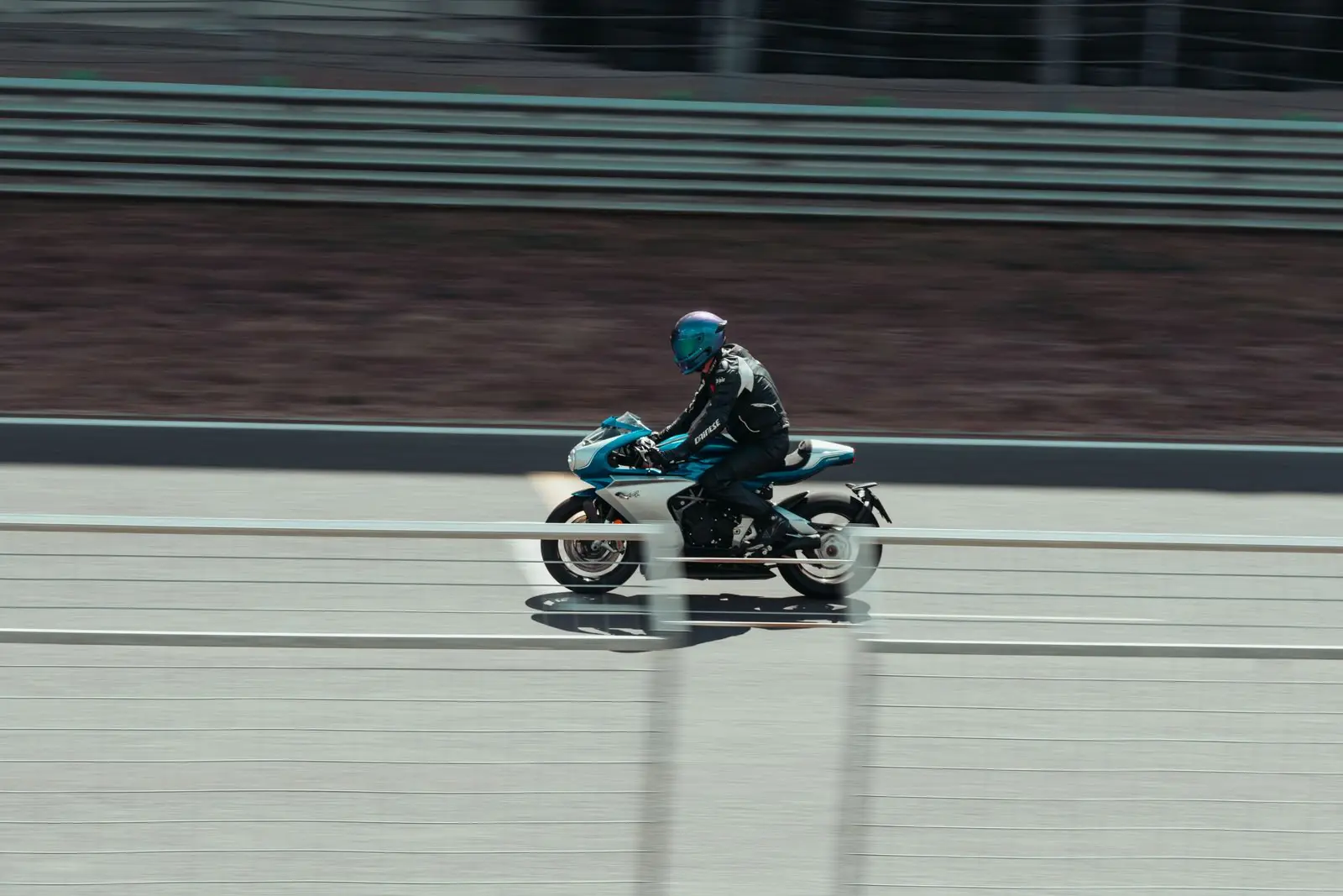 Motorcycle rider on a paved racing circuit