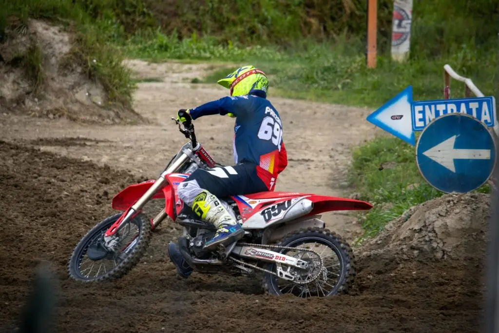 Motocross rider turning on a dirt circuit