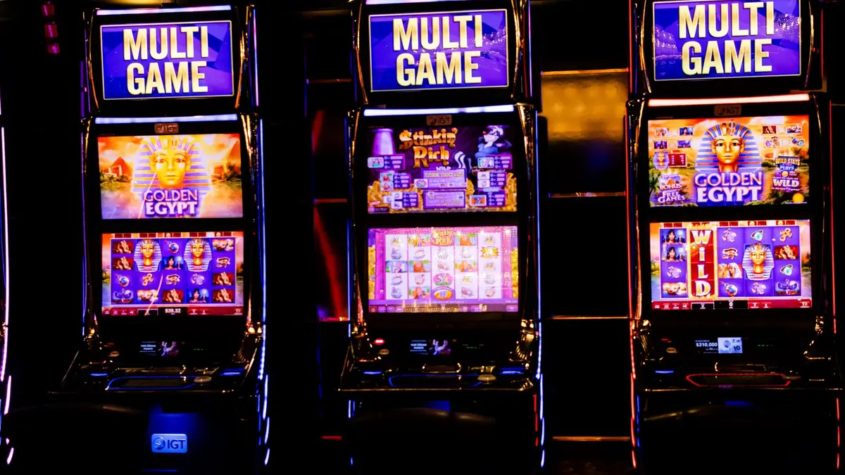 Illuminated slot machines representing stake and spin controls