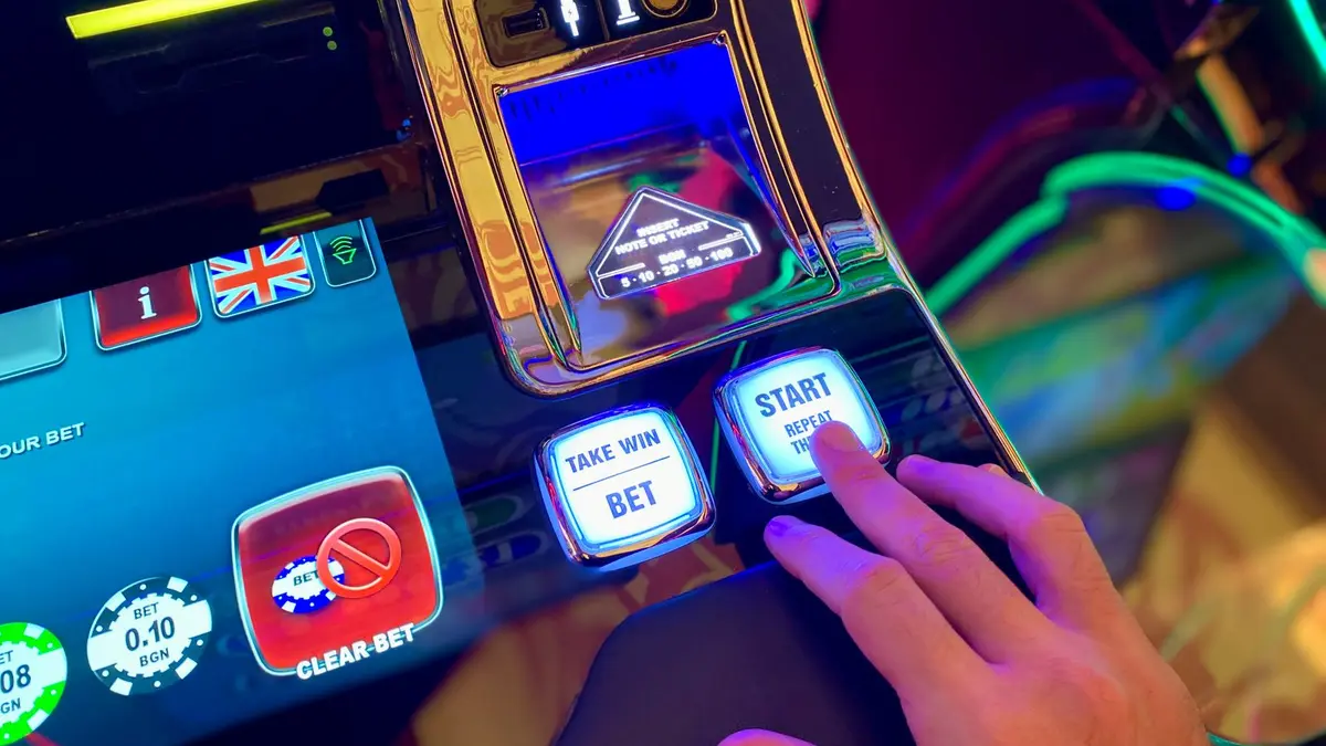 Hand using a slot-machine control panel
