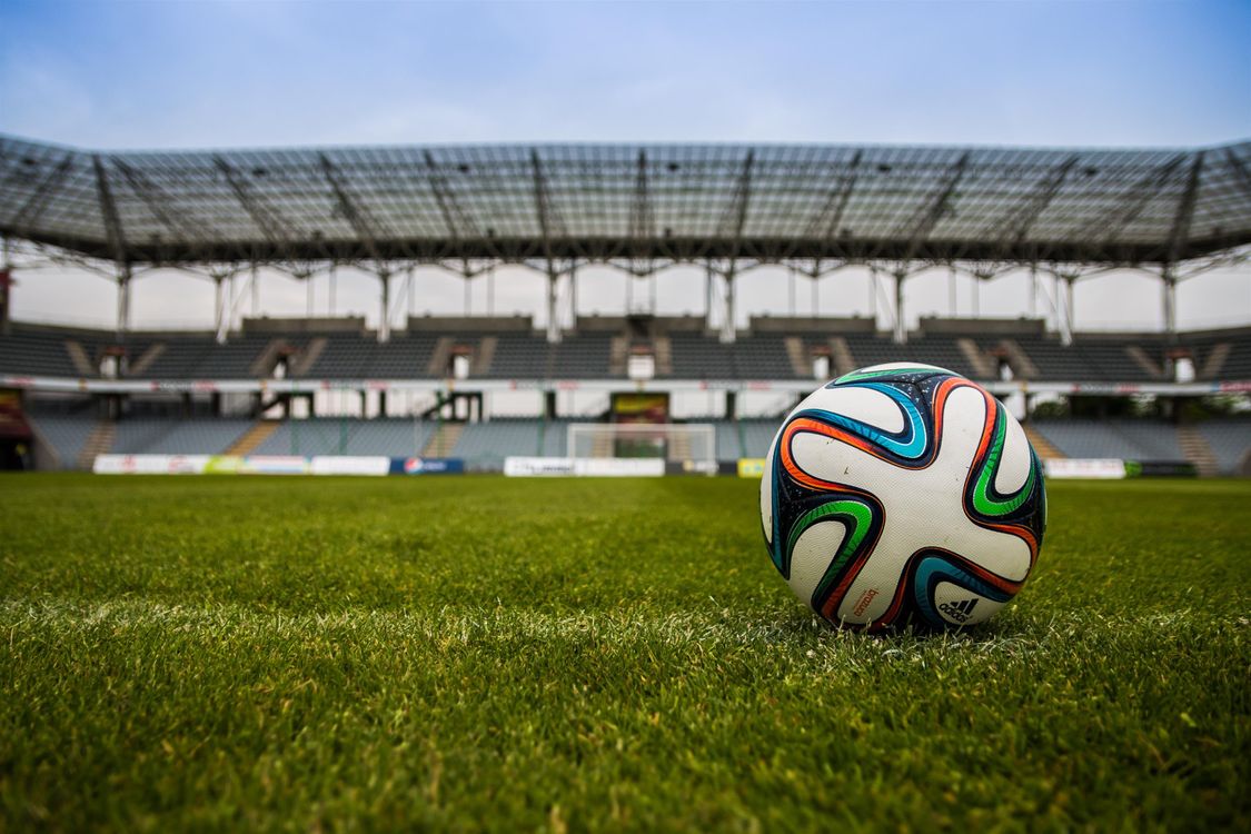 Football on a pitch, illustrating match and outright Cup markets